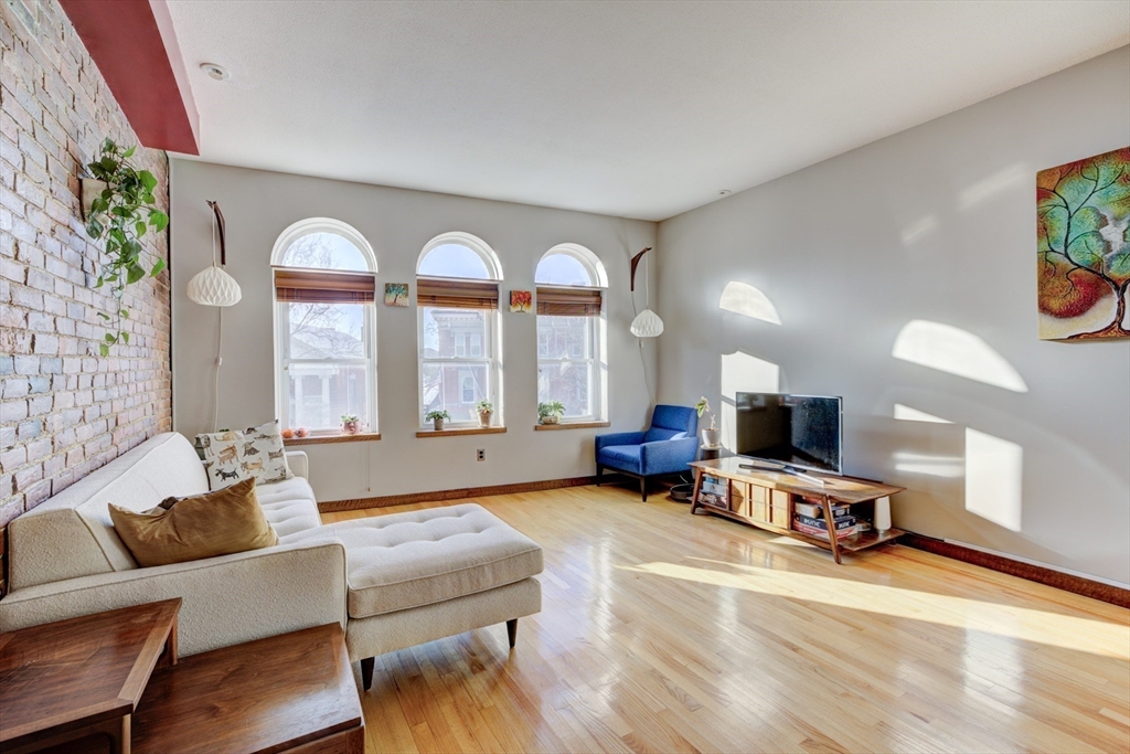 231 Main Street, Unit 3R Northampton, MA 01060 - Photo 2 of 22 a living room with furniture flat screen tv and a large window