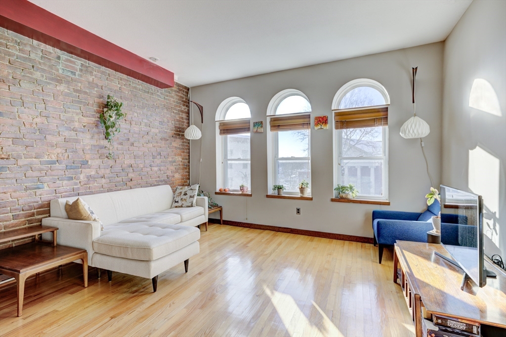 231 Main Street, Unit 3R Northampton, MA 01060 - Photo 5 of 23 a living room with couches and a large window with rug floor