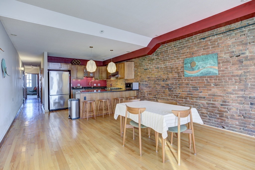 231 Main Street, Unit 3R Northampton, MA 01060 - Photo 6 of 23 a dining room with furniture and wooden floor