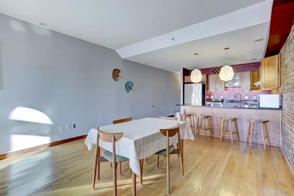 a view of a dining room with furniture and wooden floor