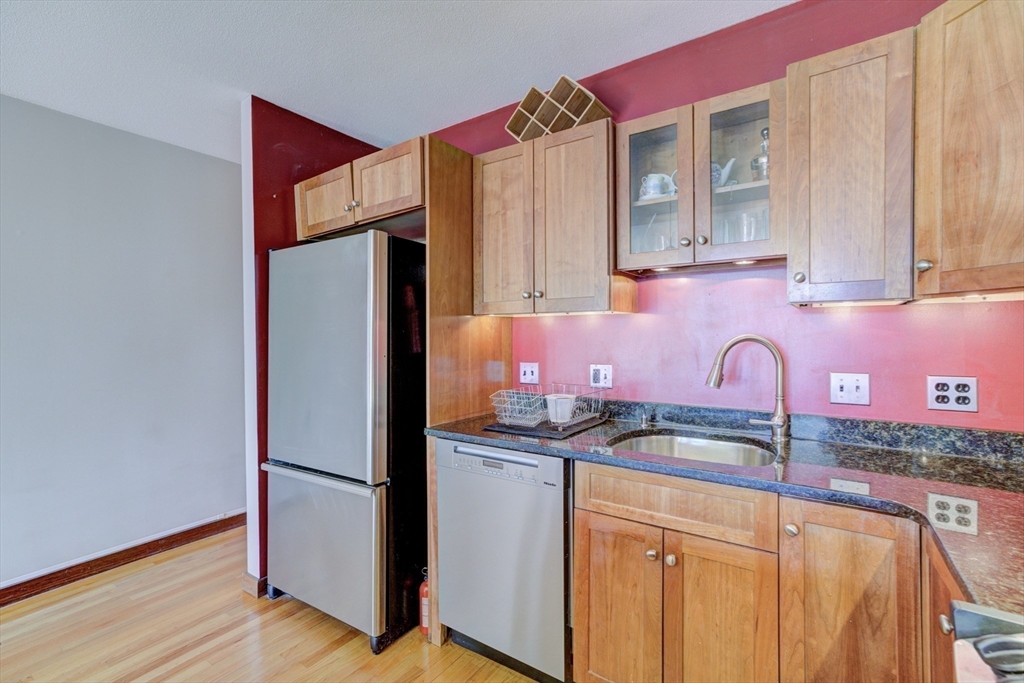 231 Main Street, Unit 3R Northampton, MA 01060 - Photo 10 of 22 a kitchen with stainless steel appliances granite countertop a refrigerator and a sink