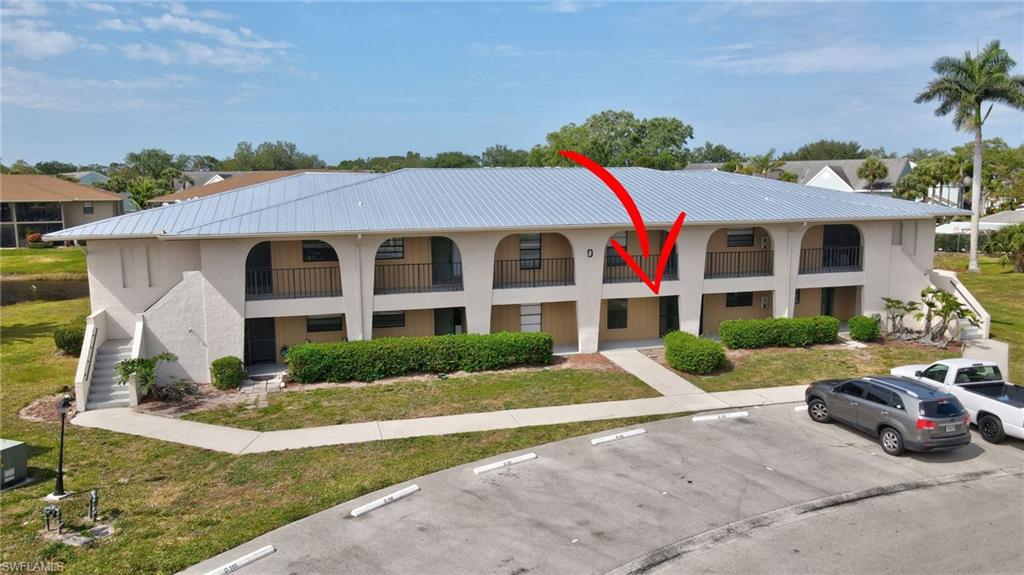 151 Cypress Way East, Unit D3 Naples, FL 34110 - Photo 1 of 46 View of property featuring uncovered parking