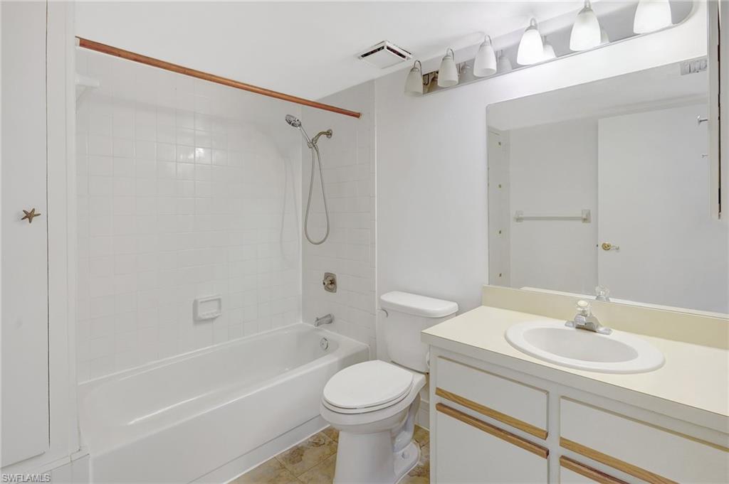 151 Cypress Way East, Unit D3 Naples, FL 34110 - Photo 11 of 46 Bathroom featuring tub / shower combination, visible vents, toilet, and vanity
