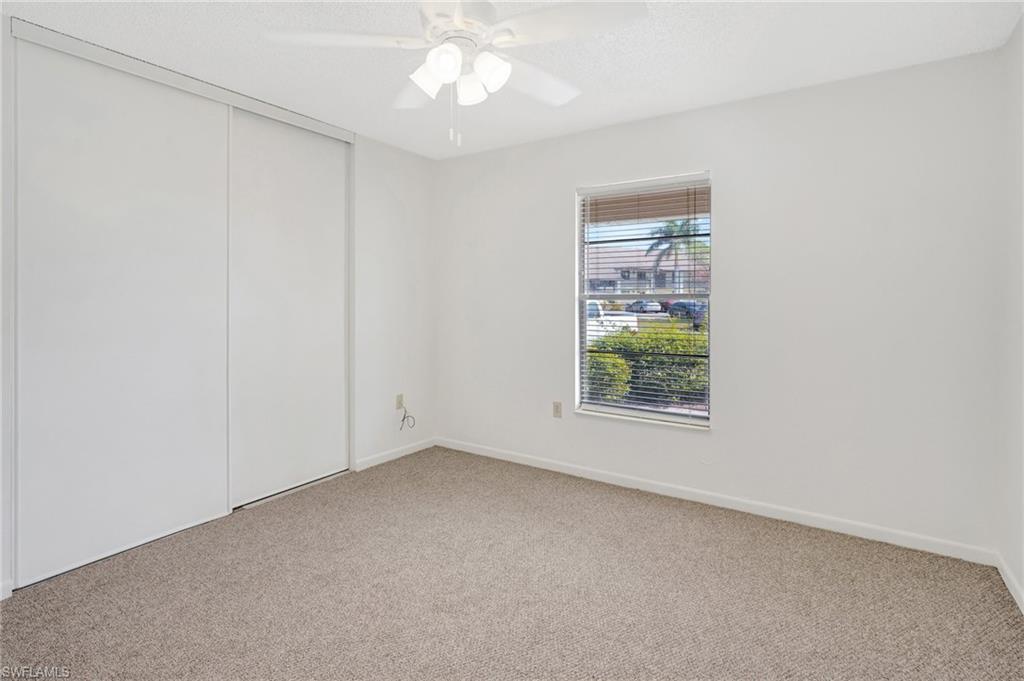 151 Cypress Way East, Unit D3 Naples, FL 34110 - Photo 15 of 46 Spare room featuring light colored carpet, ceiling fan, and baseboards