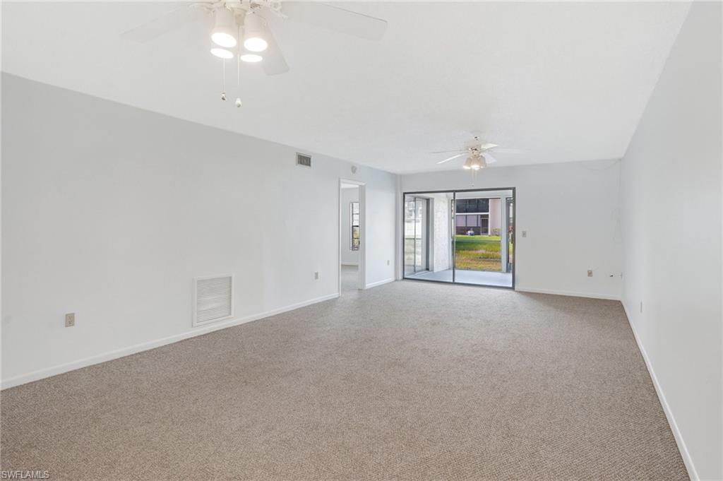 151 Cypress Way East, Unit D3 Naples, FL 34110 - Photo 17 of 46 Empty room featuring baseboards, visible vents, carpet floors, and a ceiling fan