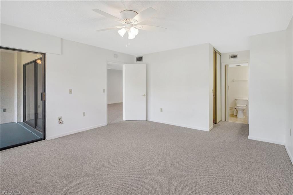 151 Cypress Way East, Unit D3 Naples, FL 34110 - Photo 26 of 46 Unfurnished bedroom featuring baseboards, visible vents, and light colored carpet