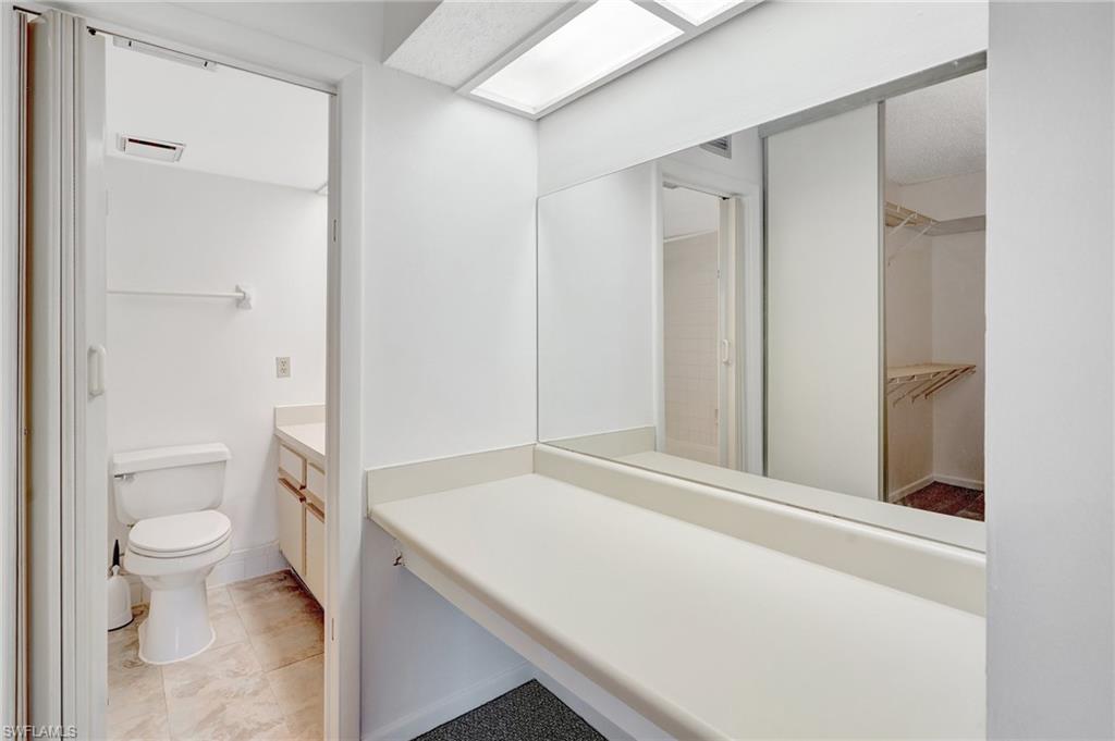 151 Cypress Way East, Unit D3 Naples, FL 34110 - Photo 29 of 46 Full bath with visible vents, toilet, a spacious closet, and vanity