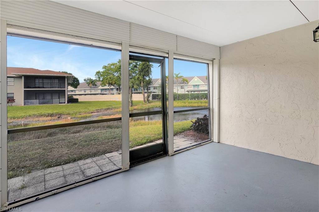 151 Cypress Way East, Unit D3 Naples, FL 34110 - Photo 35 of 46 Unfurnished sunroom with a residential view and a water view