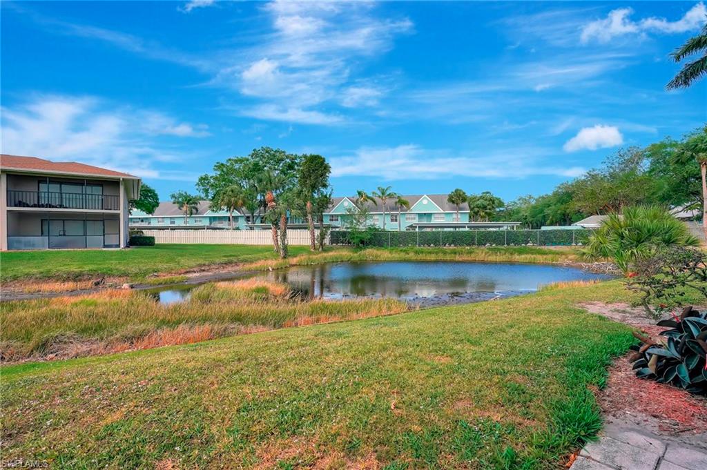 151 Cypress Way East, Unit D3 Naples, FL 34110 - Photo 38 of 46 View of yard with a water view and fence