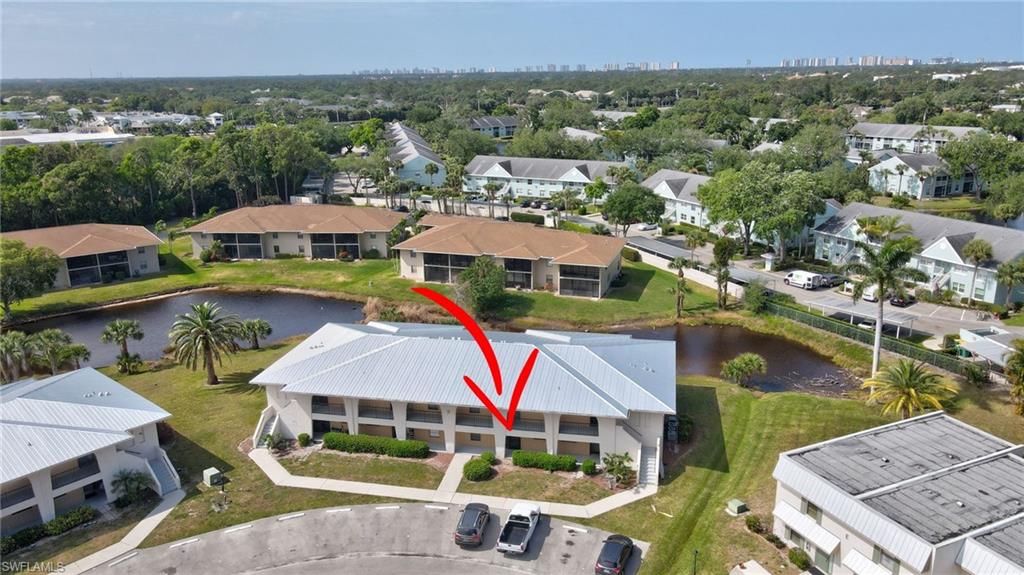 151 Cypress Way East, Unit D3 Naples, FL 34110 - Photo 41 of 46 Drone / aerial view with a residential view and a water view