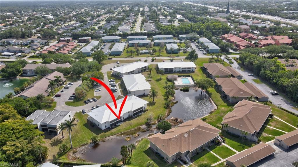 151 Cypress Way East, Unit D3 Naples, FL 34110 - Photo 42 of 46 Drone / aerial view with a residential view and a water view