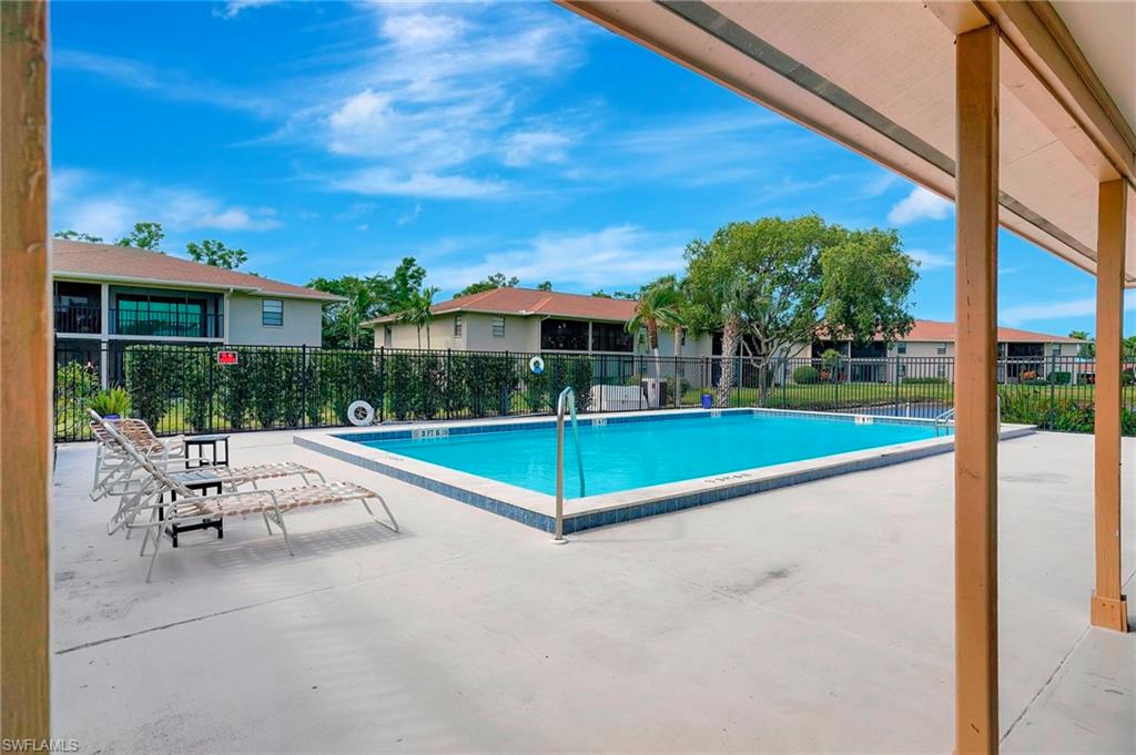 151 Cypress Way East, Unit D3 Naples, FL 34110 - Photo 46 of 46 Community pool featuring fence and a patio area