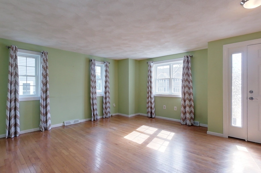 34 Lowell Road, Unit 12 Pepperell, MA 01463 - Photo 13 of 31 an empty room with wooden floor and windows