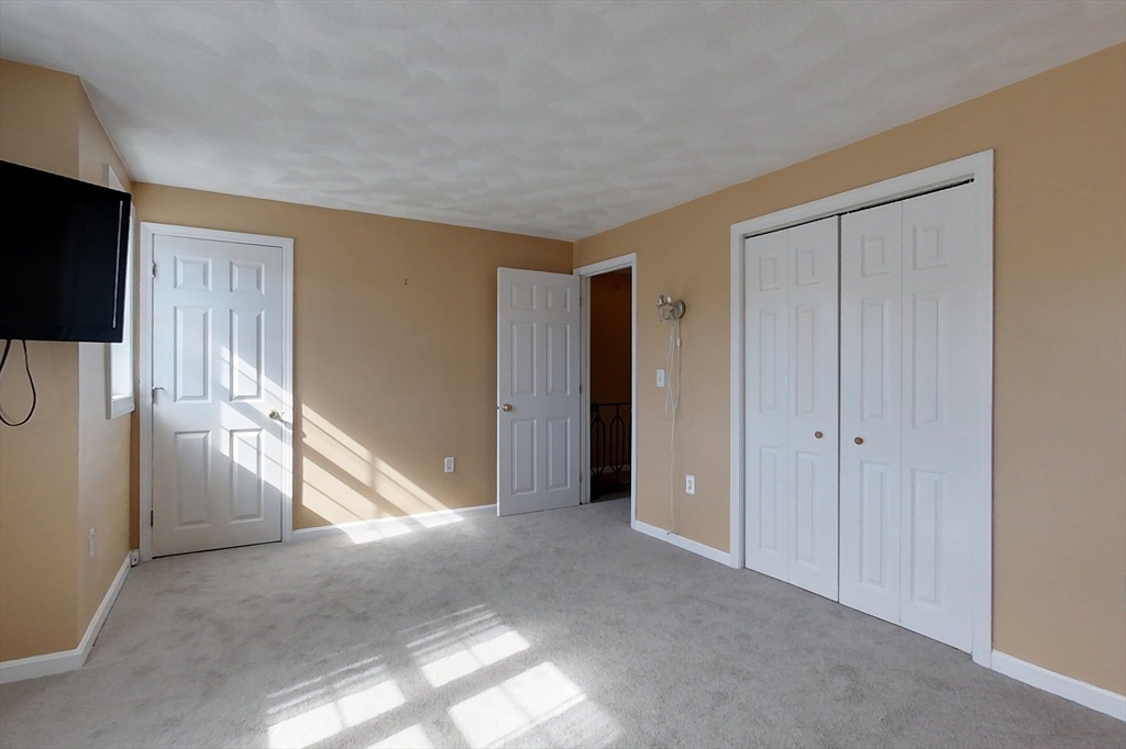 34 Lowell Road, Unit 12 Pepperell, MA 01463 - Photo 16 of 31 a view of an empty room with a fireplace