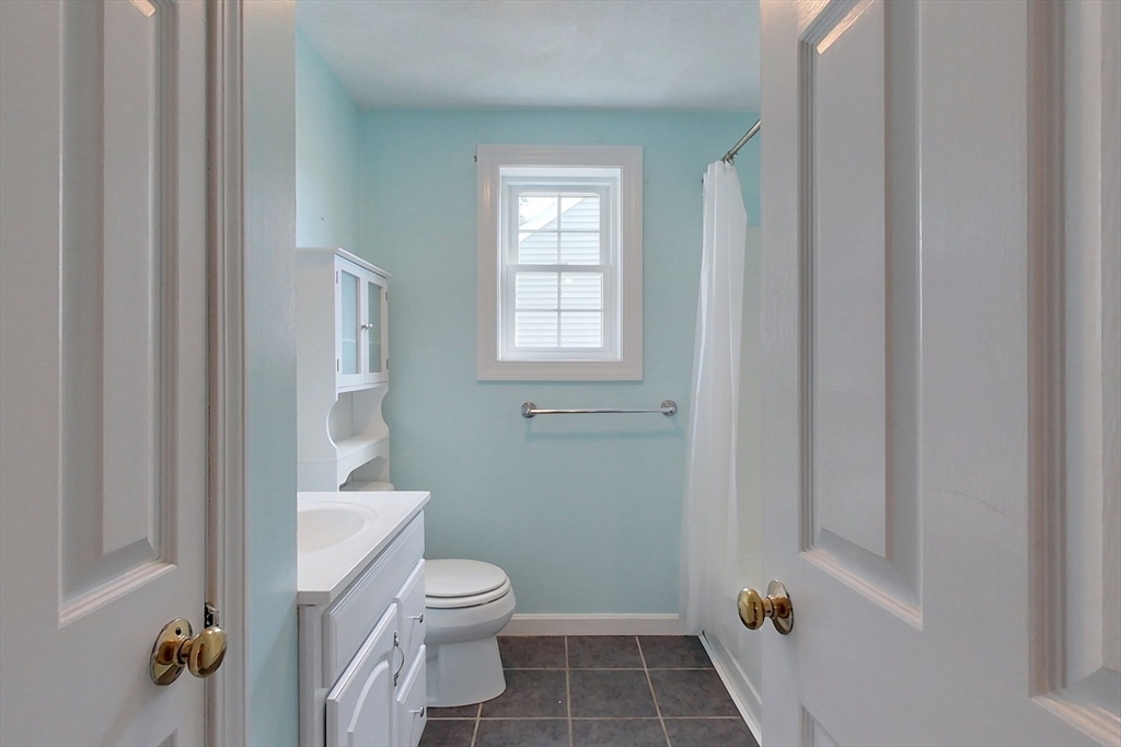34 Lowell Road, Unit 12 Pepperell, MA 01463 - Photo 19 of 31 a white toilet sitting next to a bathroom sink and tub