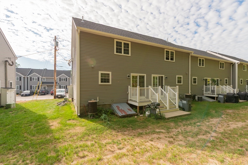 34 Lowell Road, Unit 12 Pepperell, MA 01463 - Photo 2 of 31 a view of a house with backyard porch and sitting area