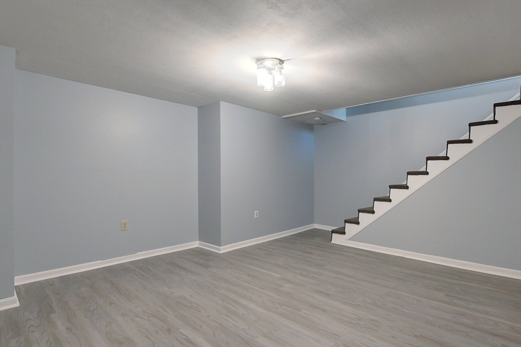 34 Lowell Road, Unit 12 Pepperell, MA 01463 - Photo 21 of 31 a view of an empty room with wooden floor