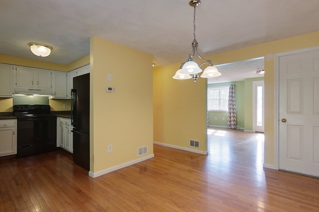 34 Lowell Road, Unit 12 Pepperell, MA 01463 - Photo 6 of 31 a view of a kitchen with wooden floor