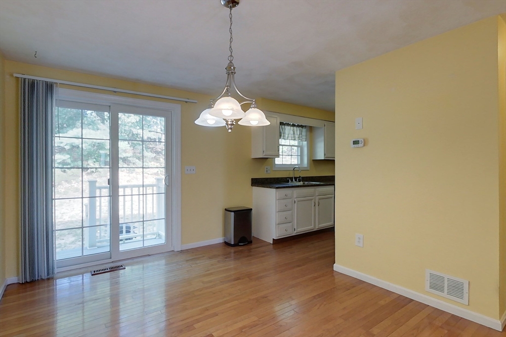 34 Lowell Road, Unit 12 Pepperell, MA 01463 - Photo 7 of 31 a view of kitchen and kitchen with wooden floor