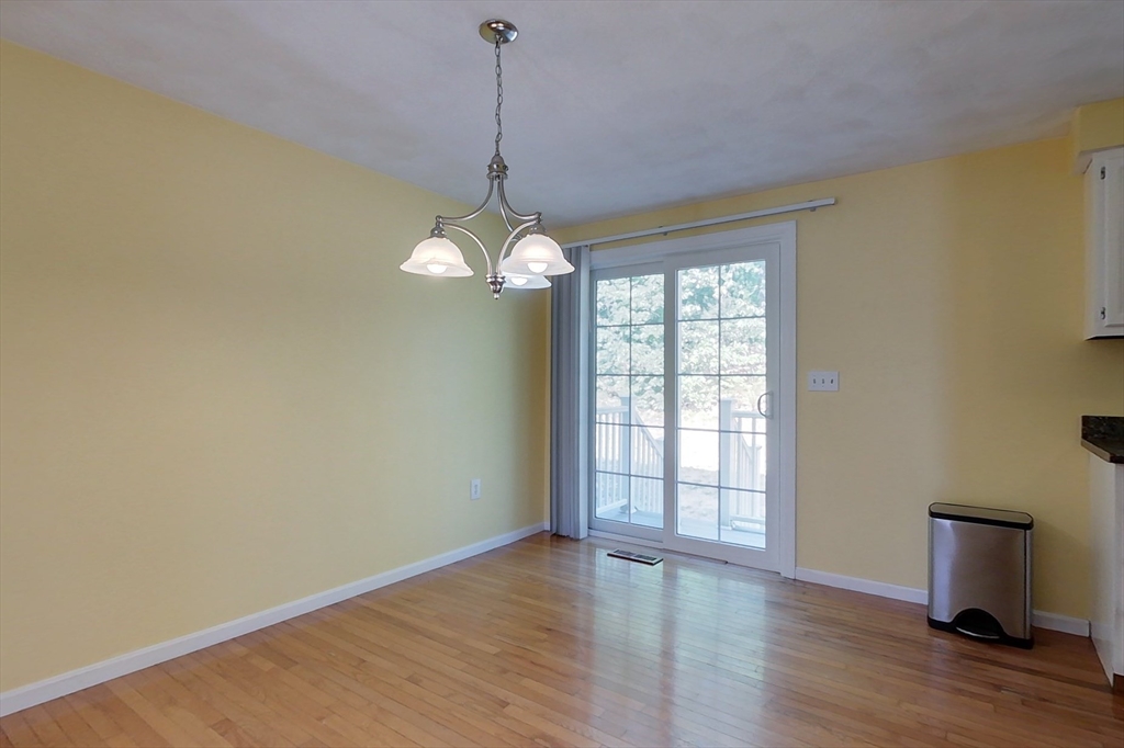 34 Lowell Road, Unit 12 Pepperell, MA 01463 - Photo 8 of 31 a view of an empty room with wooden floor and a window