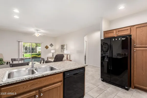 a kitchen with granite countertop a refrigerator and a sink