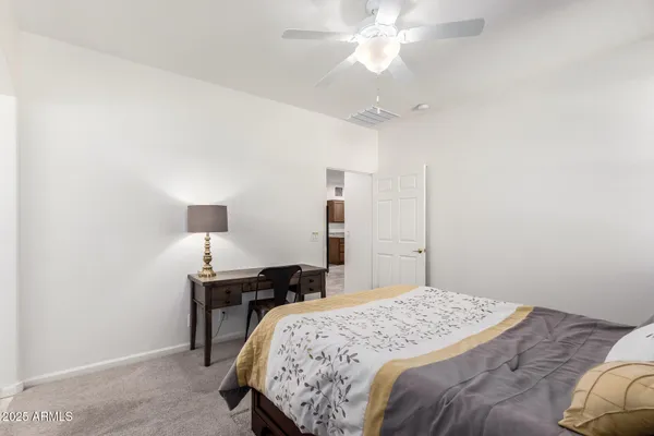 a bedroom with a bed and a table