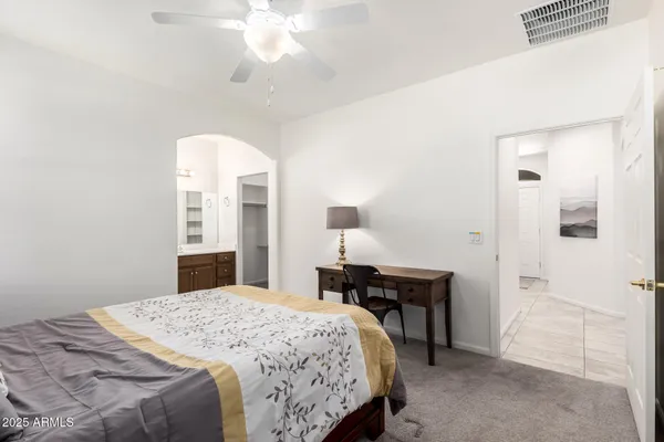 a bedroom with a bed and a chandelier