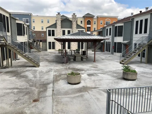 a roof deck with table and chairs
