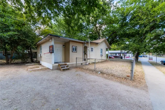 a view of a house with a yard and garage