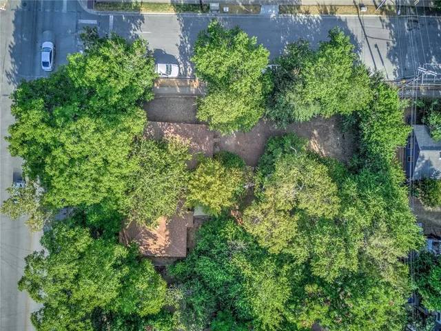 an aerial view of a house with a yard and garden