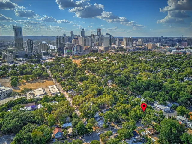 a multi story building with trees in the background