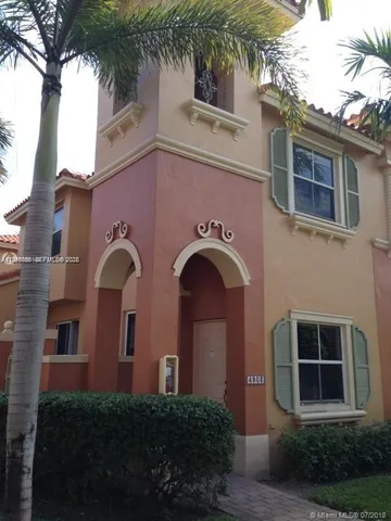 a front view of a house with plants