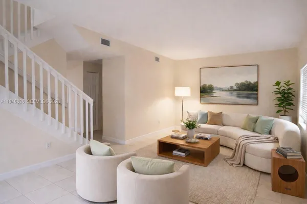a living room with furniture and a potted plant