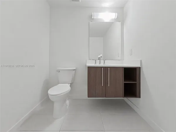 a bathroom with a toilet sink and vanity