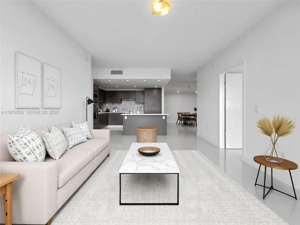a living room with furniture and a chandelier