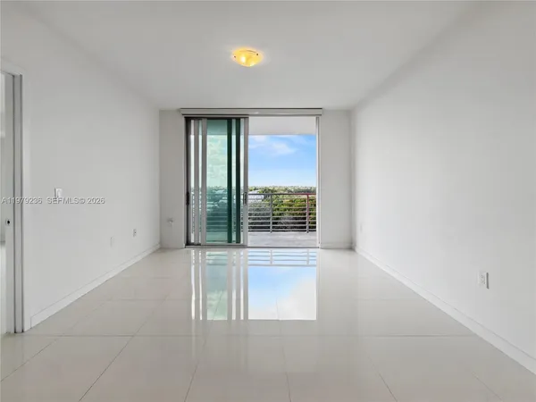 a view of an empty room with a window