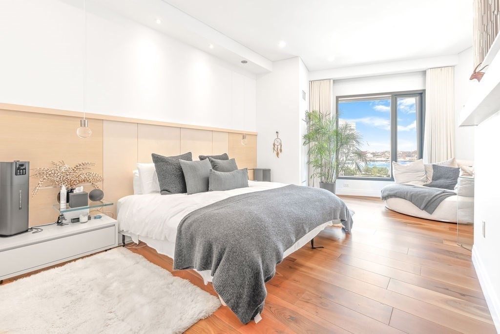 300 Pier 4 Blvd., Unit 8A Boston, MA 02210 - Photo 13 of 39 a spacious bedroom with a bed couch and a large window