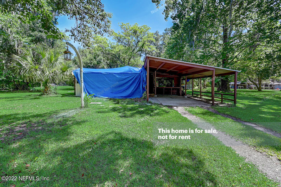 a view of a wooden deck with a yard