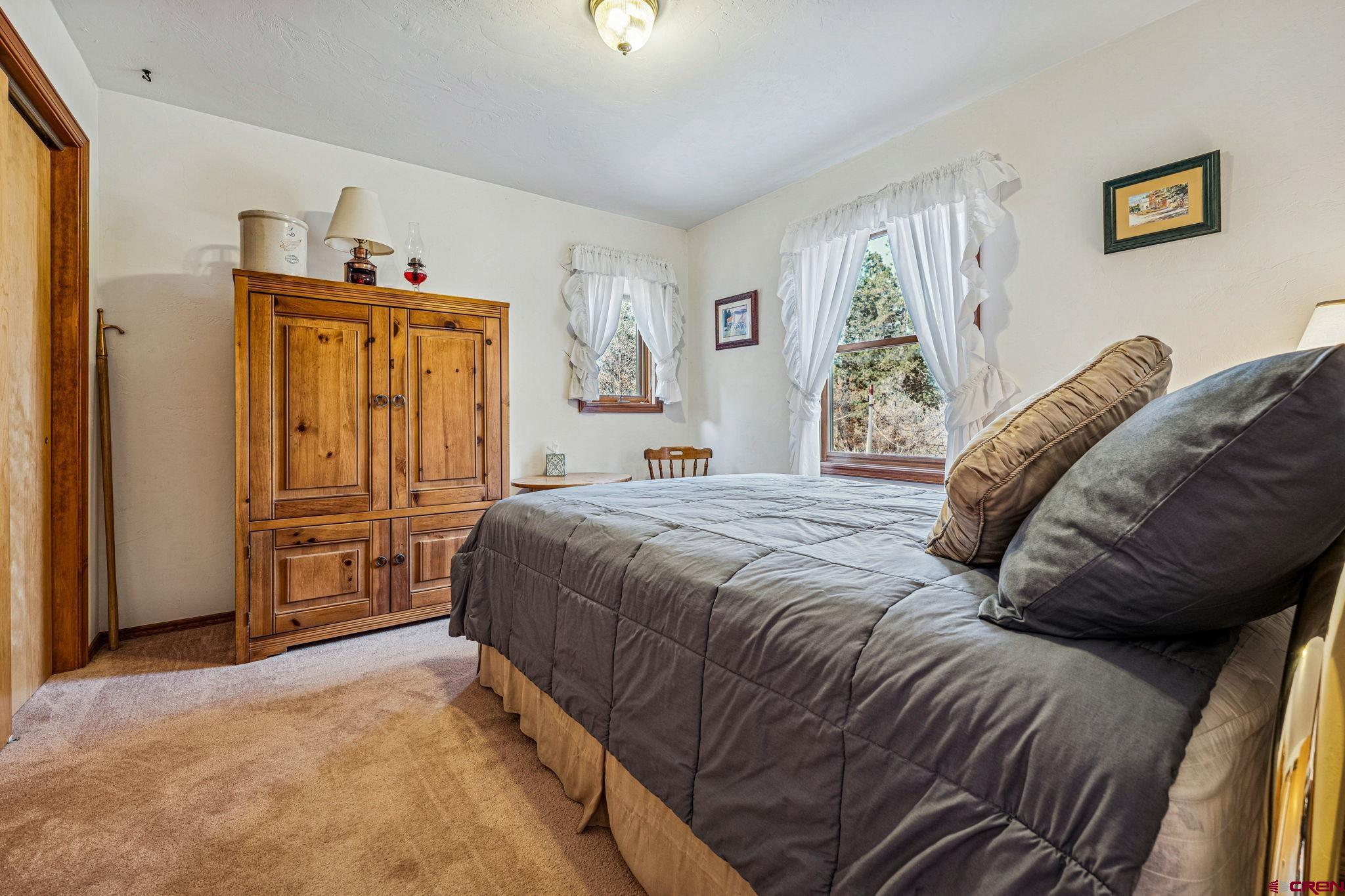 145 Cliffside Drive Durango, CO 81301 - Photo 13 of 43 a bedroom with a bed and a window