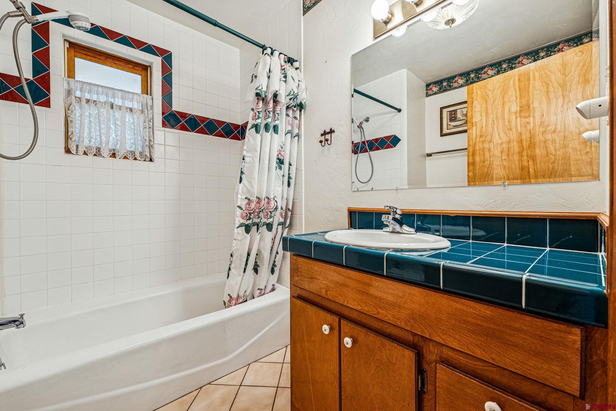 145 Cliffside Drive Durango, CO 81301 - Photo 16 of 43 a bathroom with a tub sink and mirror
