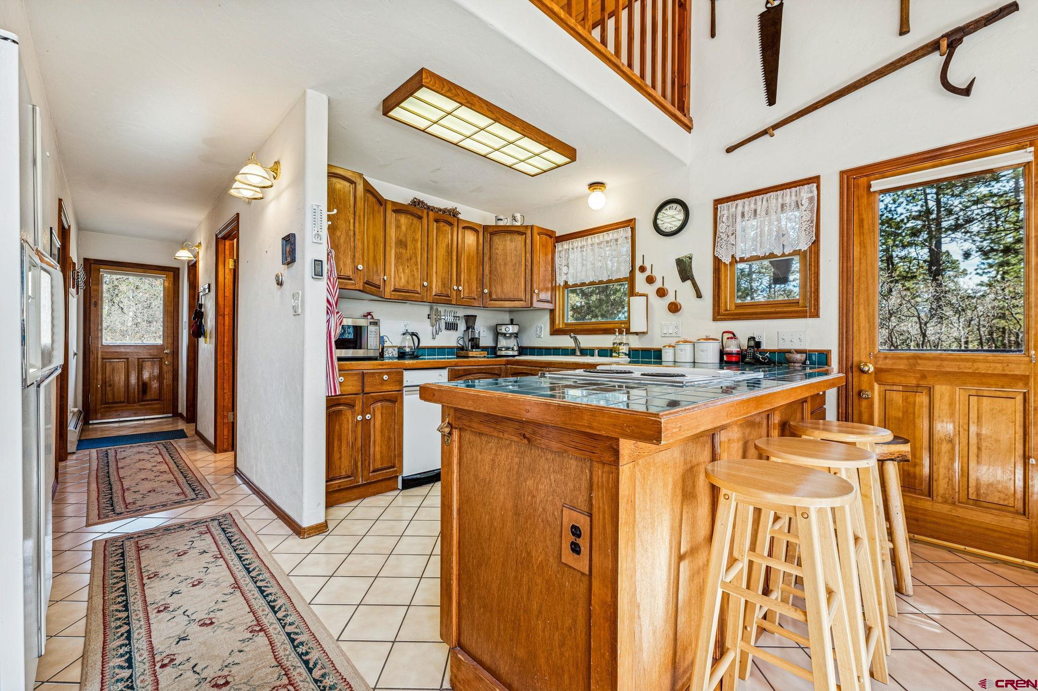 145 Cliffside Drive Durango, CO 81301 - Photo 18 of 43 a kitchen with stainless steel appliances granite countertop a refrigerator and a stove top oven