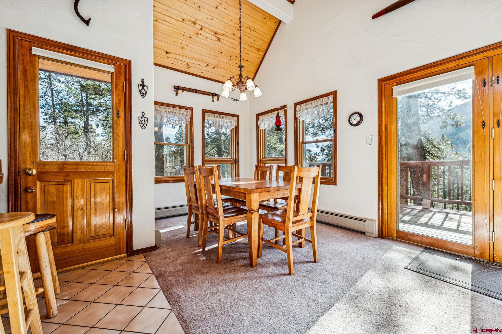 145 Cliffside Drive Durango, CO 81301 - Photo 21 of 43 a view of a dining room with furniture large windows and wooden floor