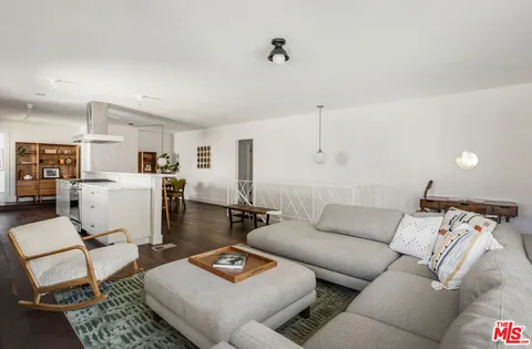a living room with furniture and kitchen view