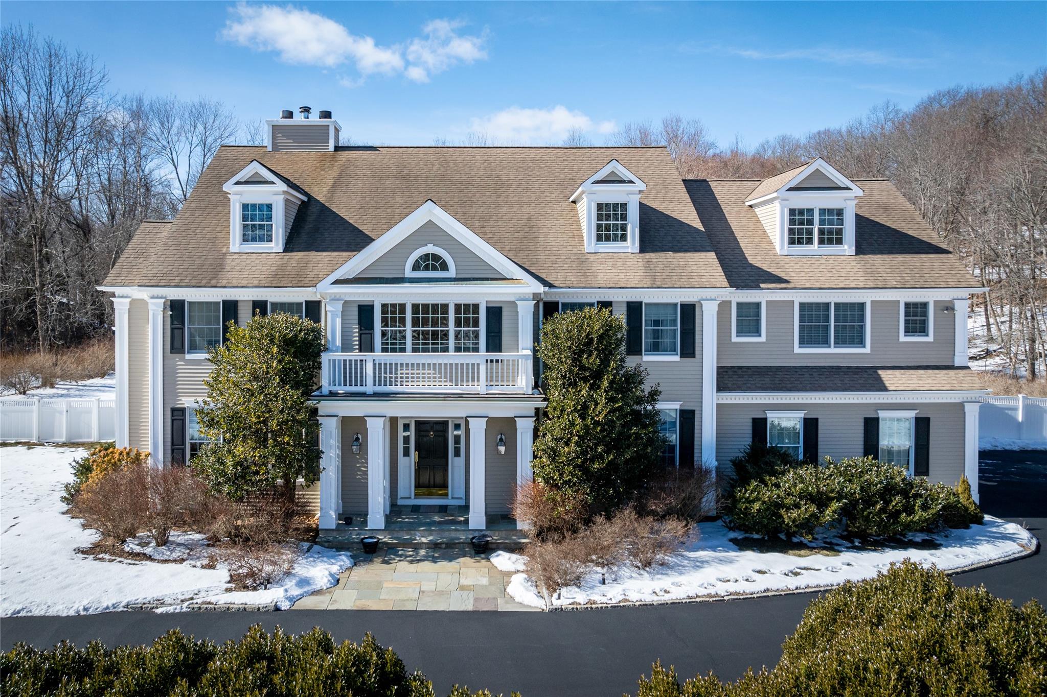 a front view of residential houses with yard and green space