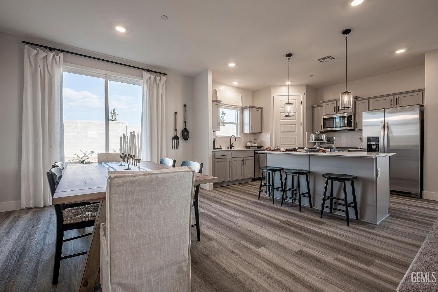 Undisclosed Address Bakersfield, CA 93311 - Photo 3 of 19 a kitchen with kitchen island a large counter top space a sink stainless steel appliances and cabinets