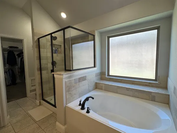 a bathroom with a bathtub and a shower