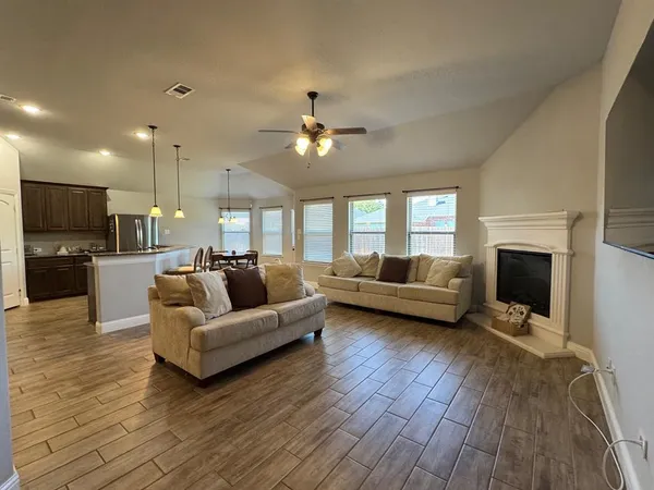 a living room with furniture and a fireplace