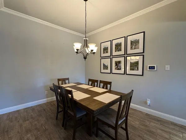 a view of a dining room with a table and chairs