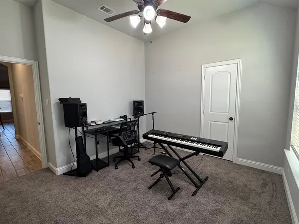 a view of a workspace with furniture and a window