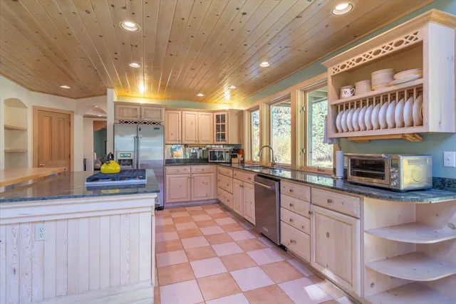 a kitchen with stainless steel appliances granite countertop a sink and cabinets
